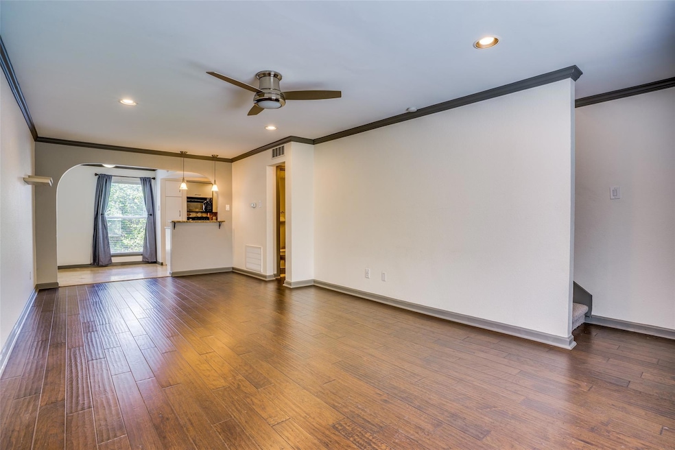 Unfurnished room with crown molding, dark wood-typ