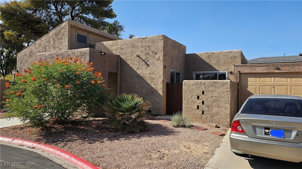 View of home's exterior featuring stucco siding and a garage