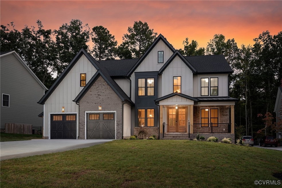 Modern farmhouse featuring a yard, a garage, and a