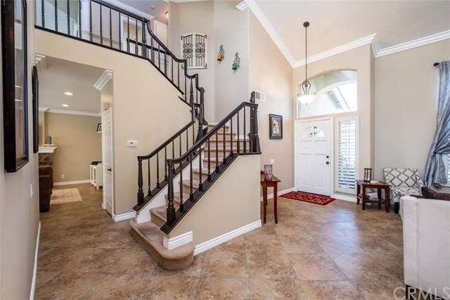 Designer travertine floors and elegant staircase