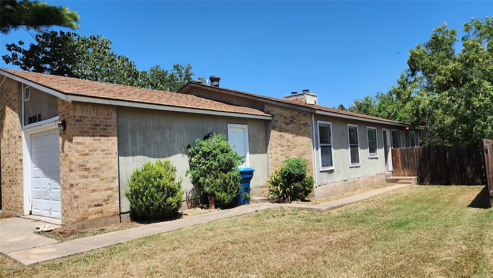 View of side of property featuring a chimney, bri