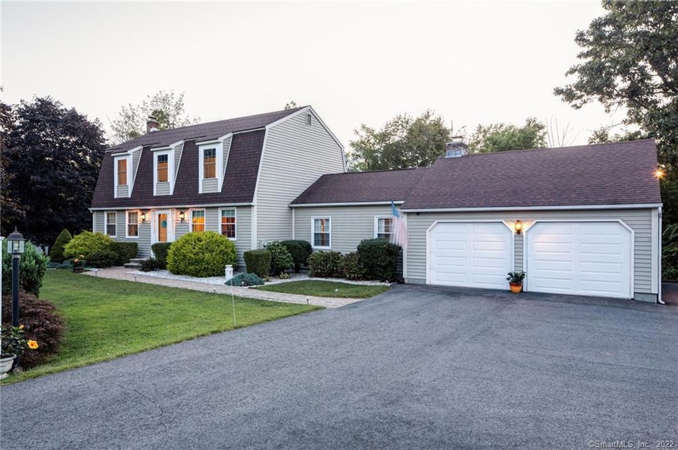 large paved driveway leading to a beautifully land