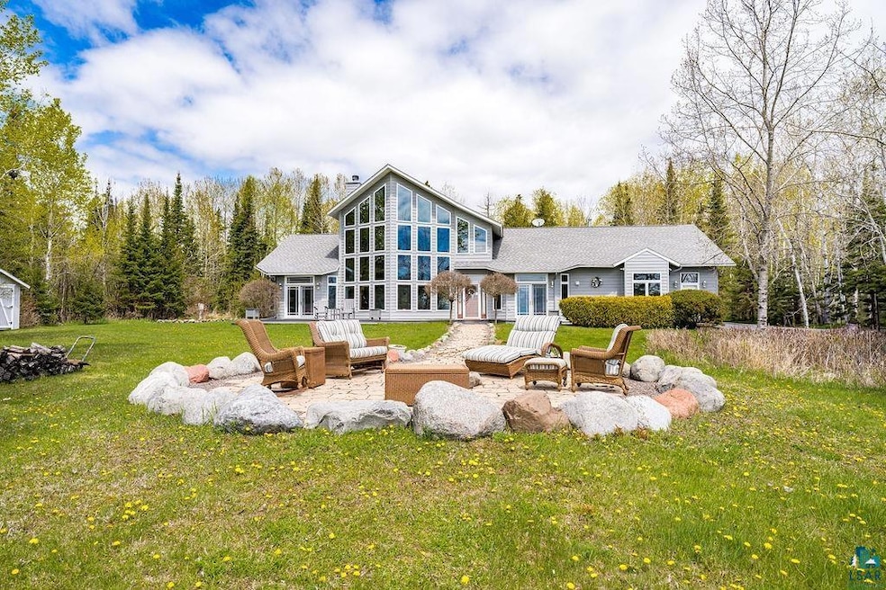 Rear view of property with an outdoor fire pit, a lawn, and a patio area
