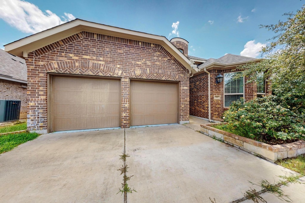 View of front of home with an attached garage, br