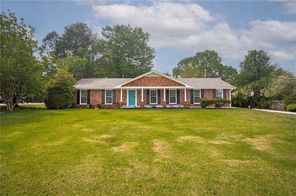 Ranch-style house featuring a front lawn, brick si