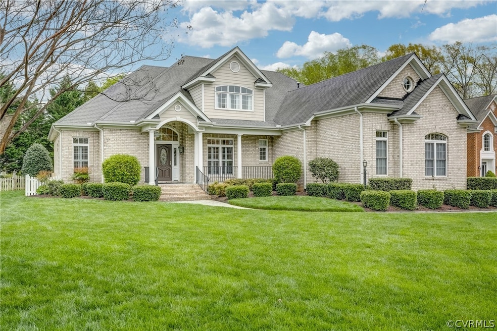 View of front of home featuring a a lush green yar