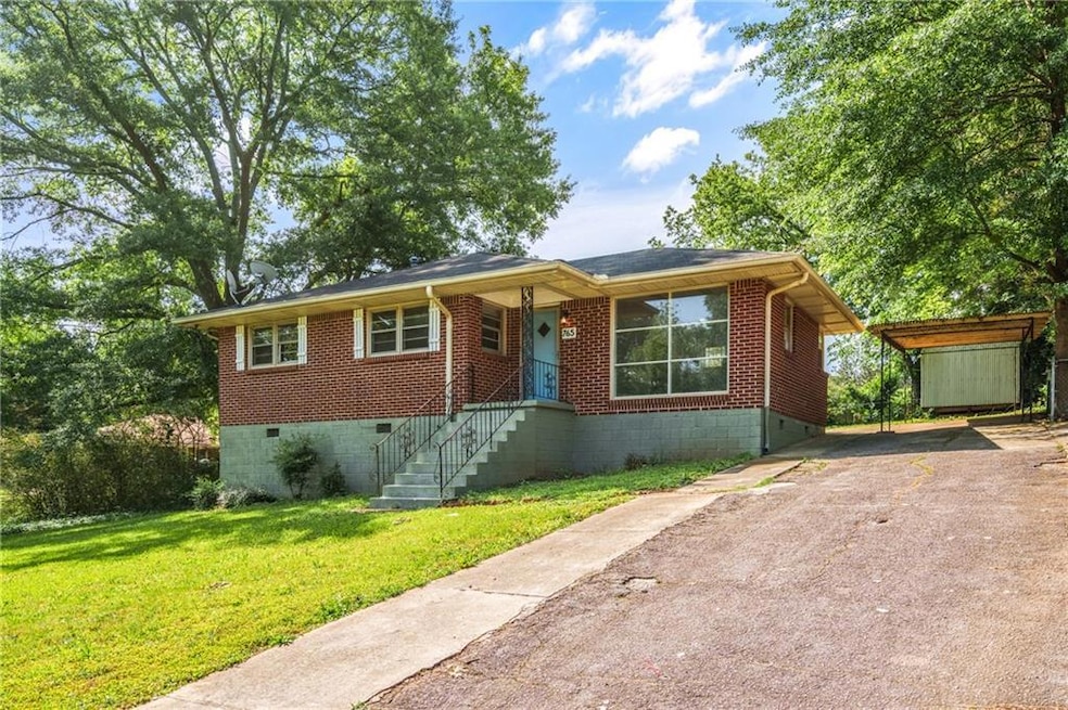 View of front facade featuring asphalt driveway, a
