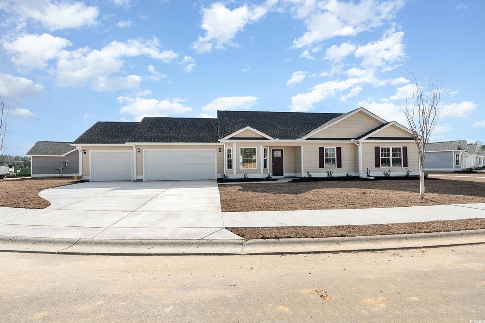 Ranch-style home featuring concrete driveway and an attached garage