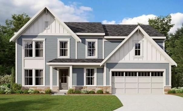 View of front facade with a garage and a front yar