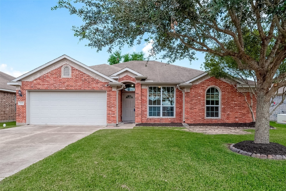 Welcome home!  This single-story brick home features a two-car garage, arched windows, and mature trees.