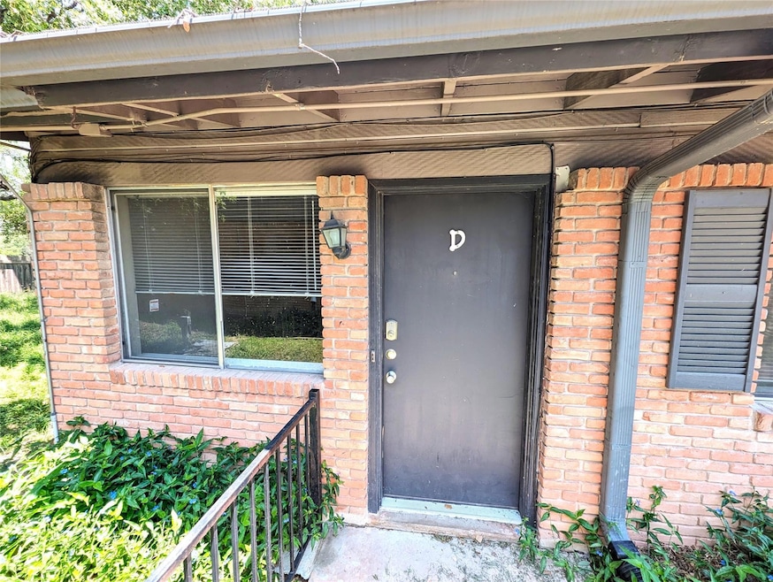 Property entrance featuring brick siding