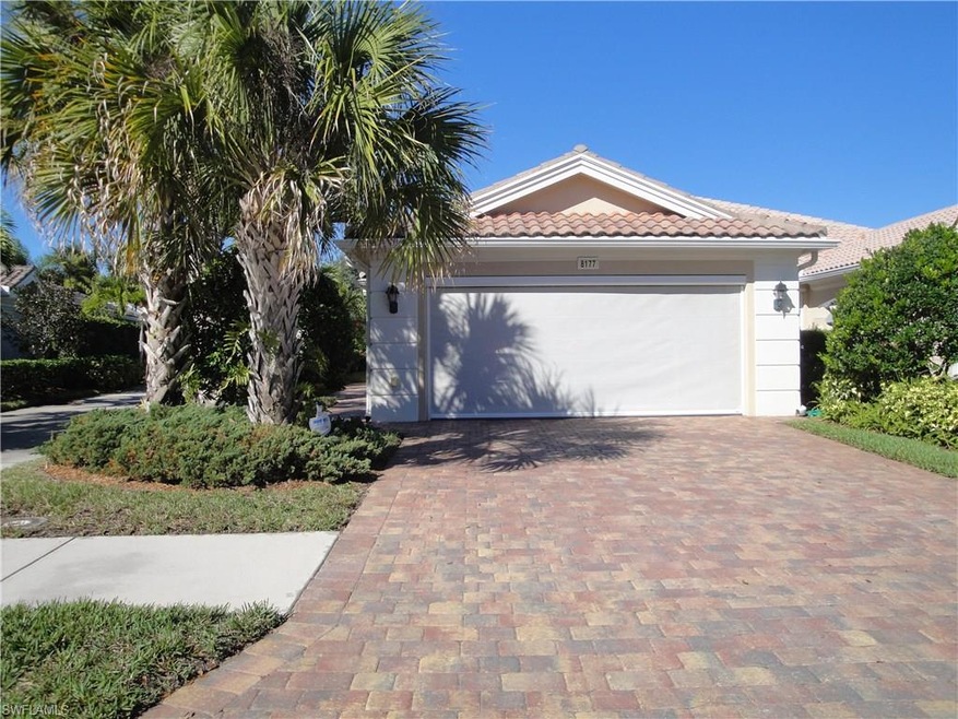 Two car garage with brick paver driveway and lovel
