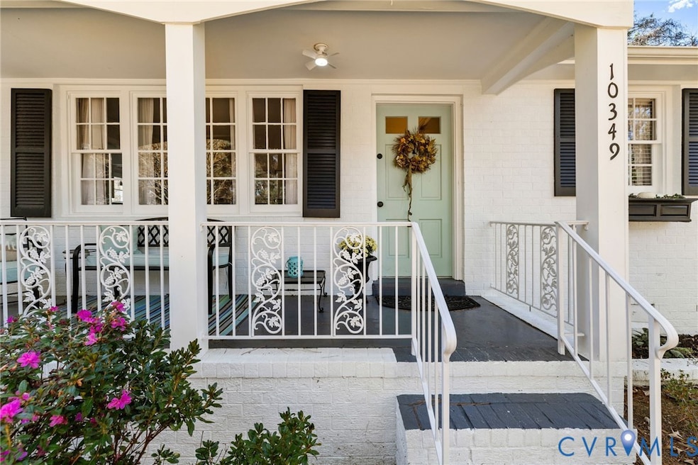 Entrance to property with covered porch and brick siding