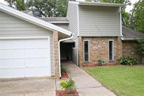 View of front of home with an attached garage, con