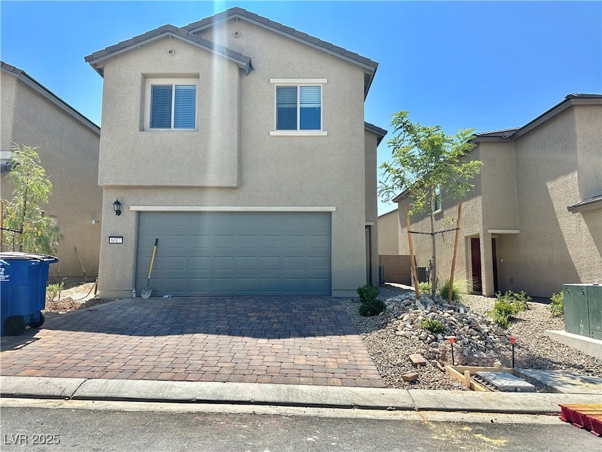 Traditional-style home featuring a garage, stucco