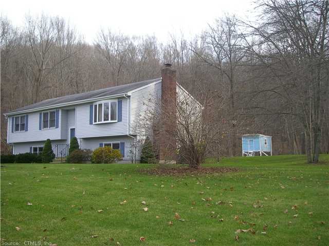 Exterior Front. 1.15 acre level corner lot in neig