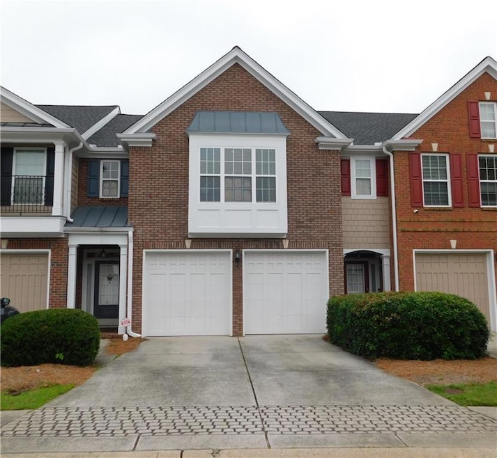 Townhome / multi-family property featuring drivewa