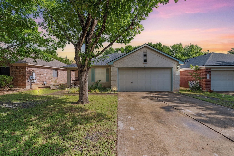 Ranch-style home with brick siding, concrete driv