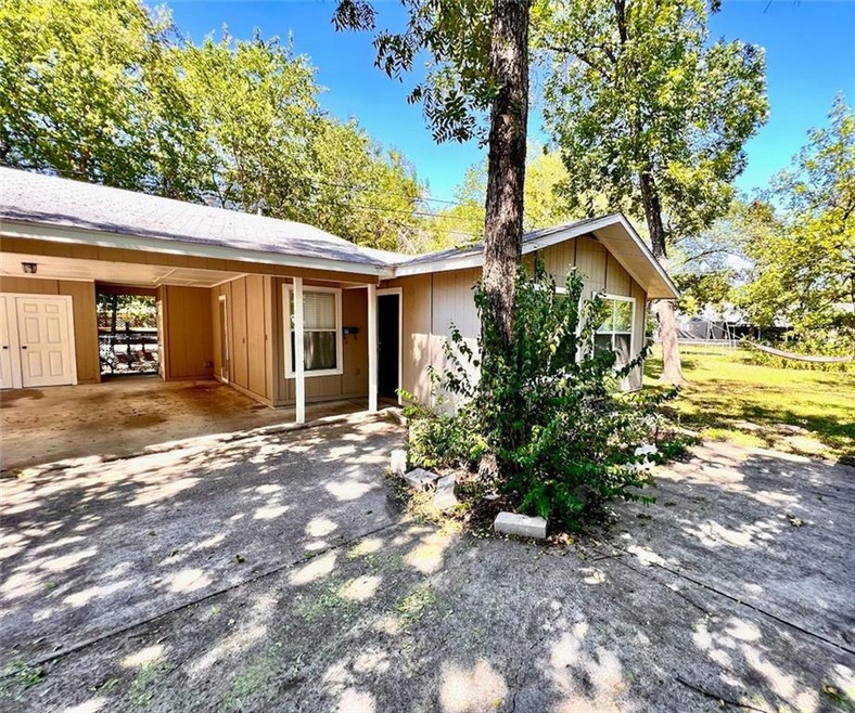 Ranch-style house featuring an attached carport a