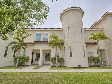 Rear view of property featuring a lawn