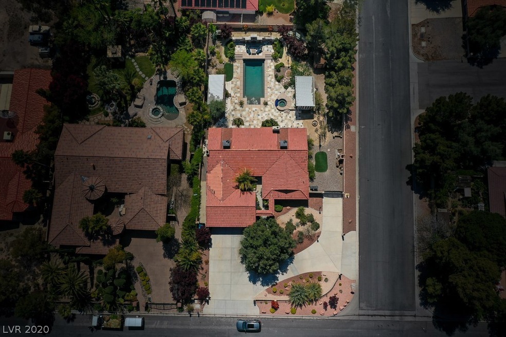 Aerial view of corner lot property with circular d