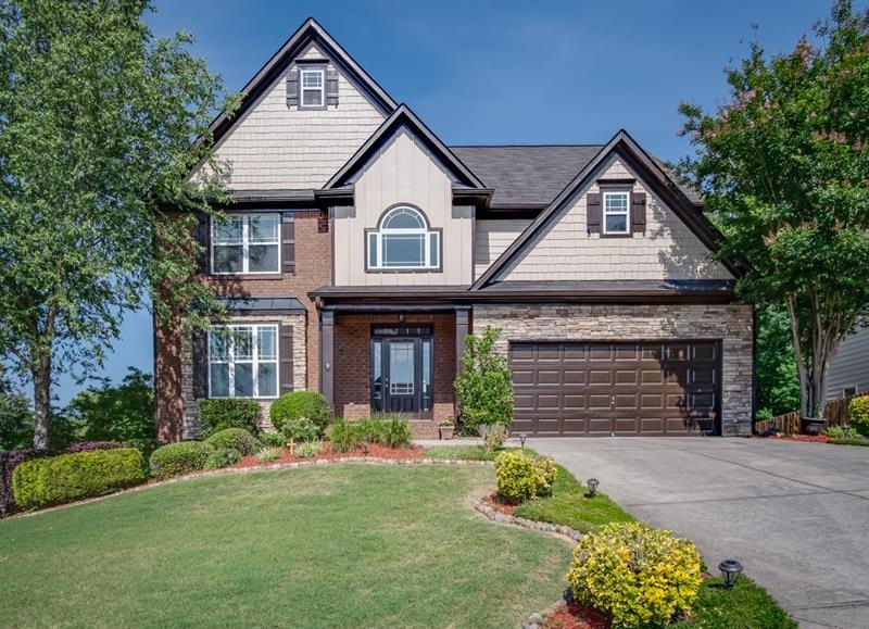 Charming home with brick, stacked stone and shingl