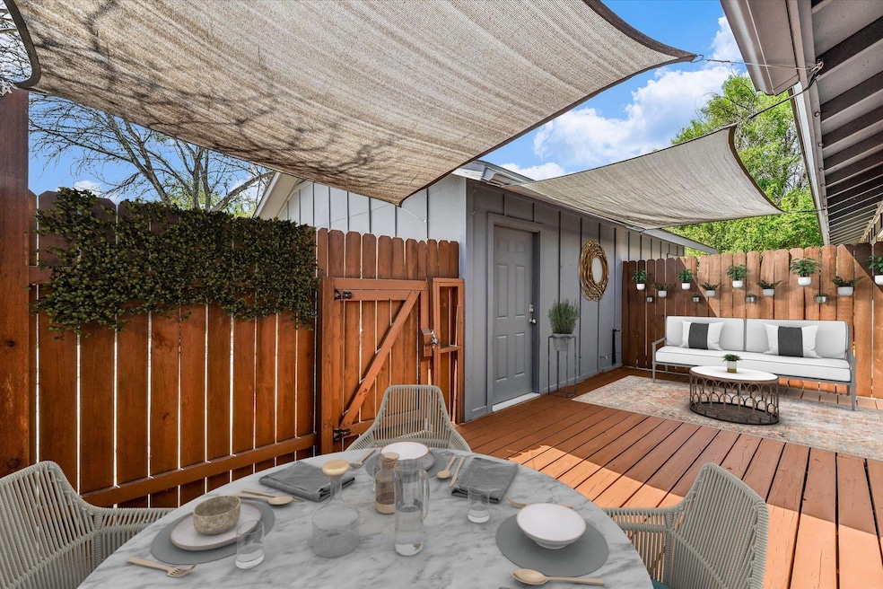 Wooden deck featuring a gate, fence, and outdoor 