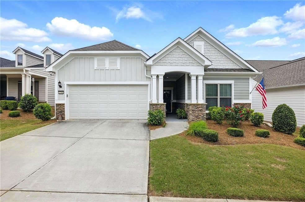 Craftsman inspired home with stone siding, an atta