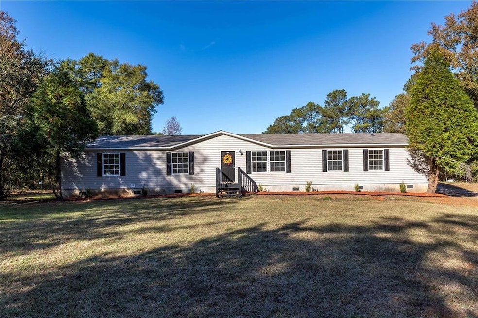 View of front of home featuring crawl space, a front yard, and entry steps