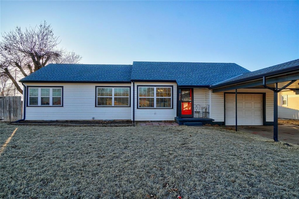 View of front of home with a garage, a front yard,