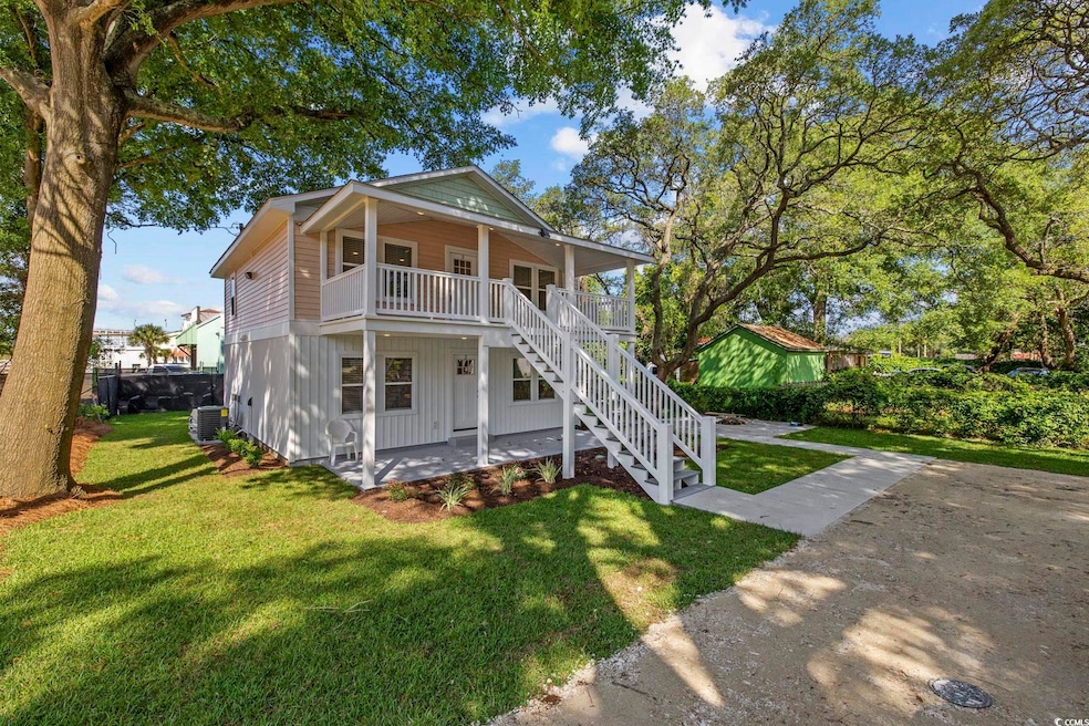 View of front of house with stairway, a front lawn, a porch, and central AC unit