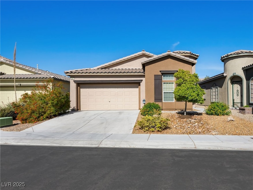 Ranch-style home featuring a tile roof, stucco sid