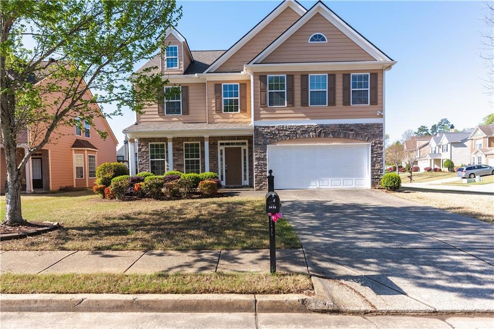 Craftsman-style home featuring stone siding, an at