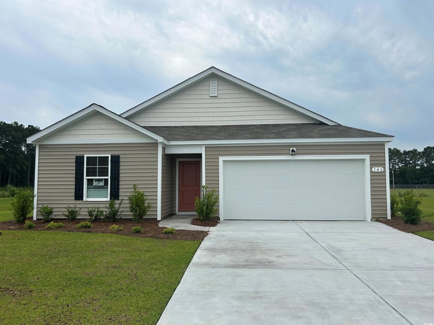 Ranch-style home with a garage and a front lawn
