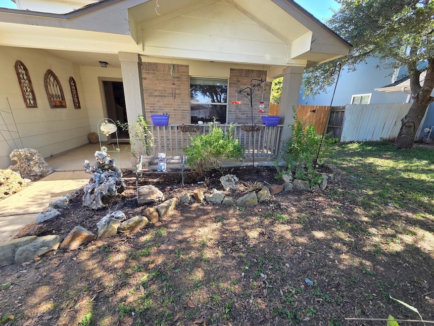 View of front of home featuring a patio and brick siding