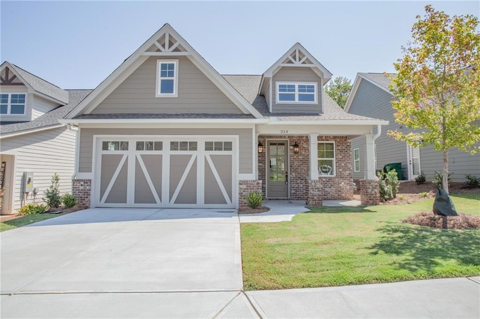 Craftsman-style house with a garage and a front la