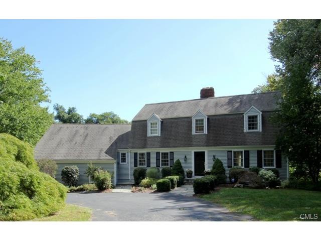 The home has mature landscaping and a circular dri