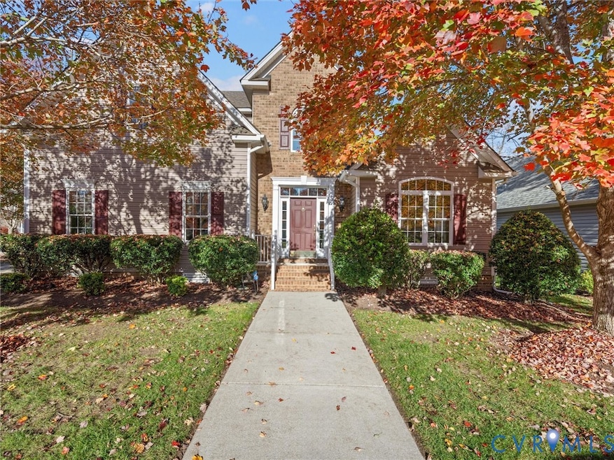 Charming transitional home on a quiet cul-de-sac in Collington, framed by mature landscaping and vibrant seasonal color.