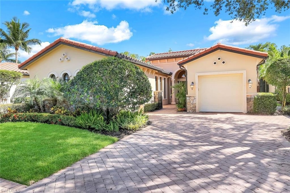 Gated entry leads to double glass doors