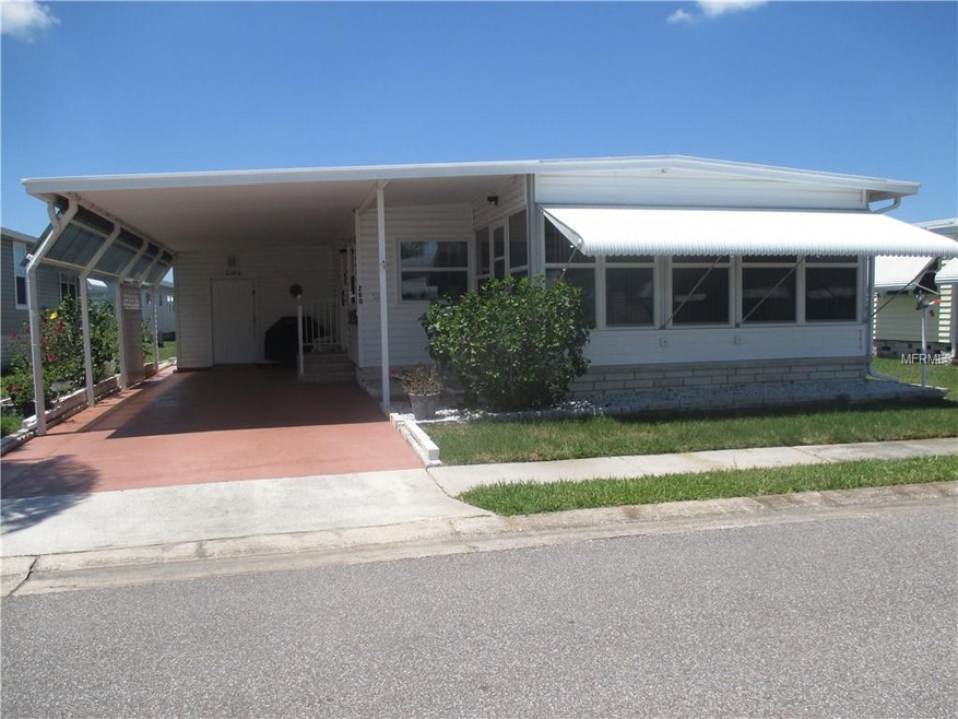 Front with landscaped hibiscus bushes