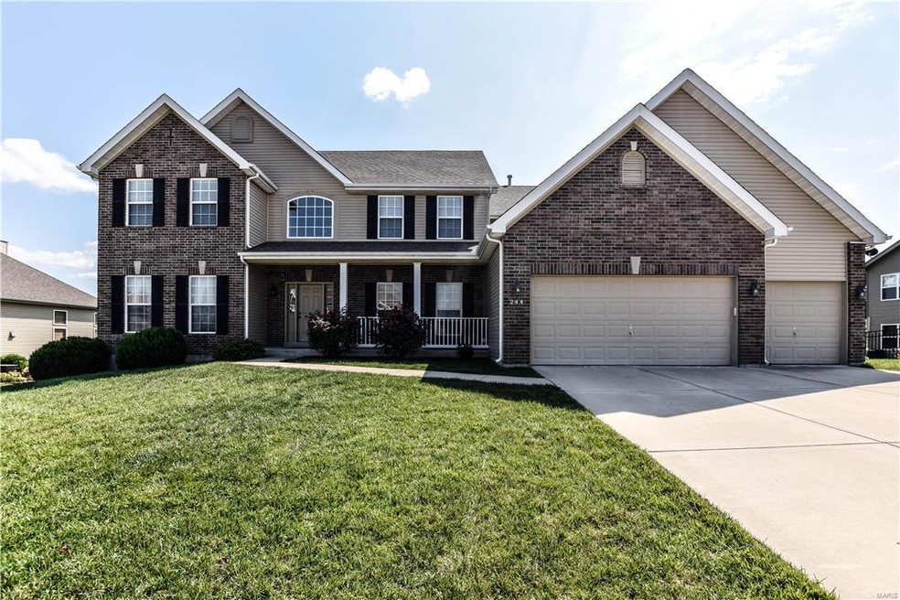 Front view of this large 1 1/2 story home with lar