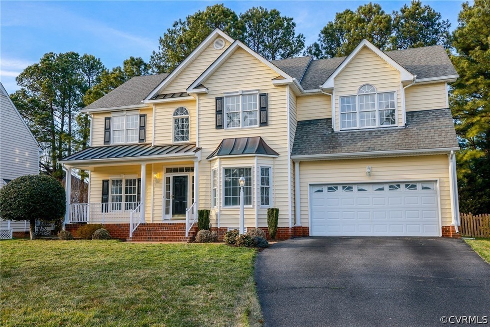 View of front of property featuring a garage, cove