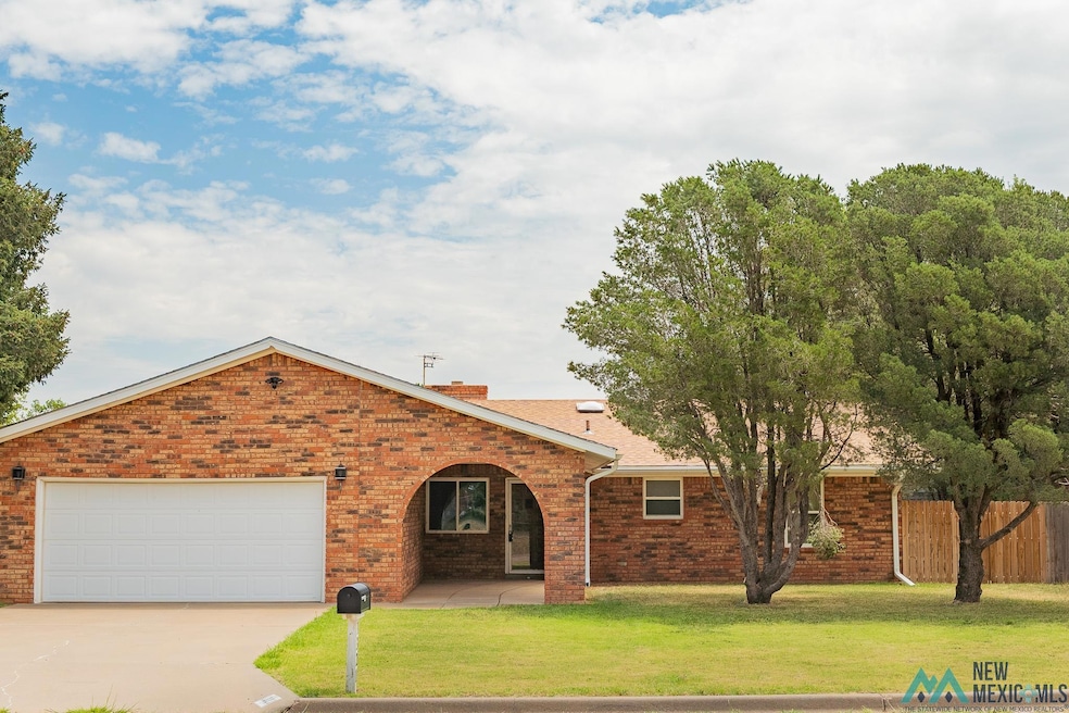 View of front of house featuring brick siding, an attached garage, concrete driveway, and a chimney