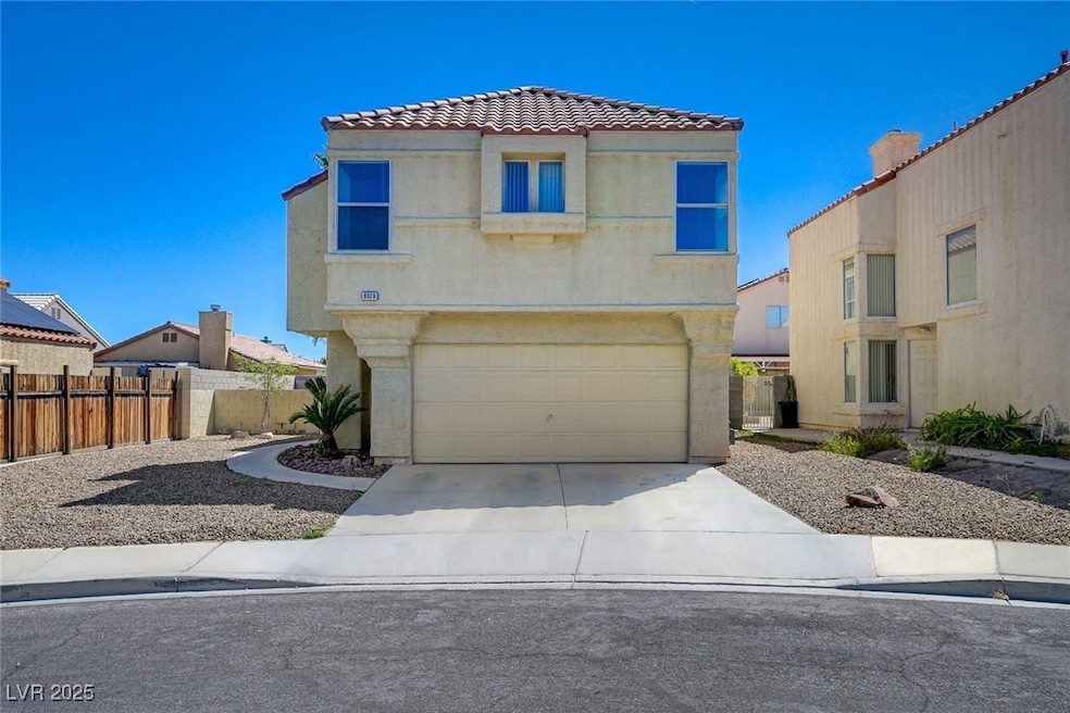 View of front of home featuring fence, concrete dr