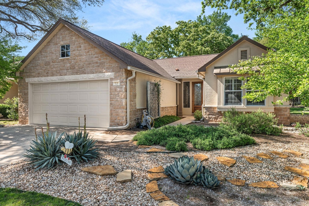 View of front of home with stucco siding, roof wi