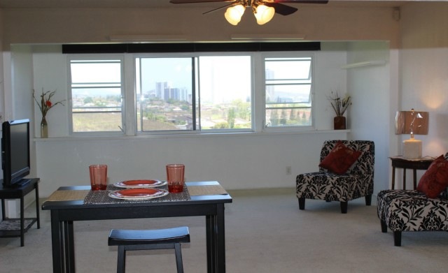 Living room with view of valley, city skyline, and
