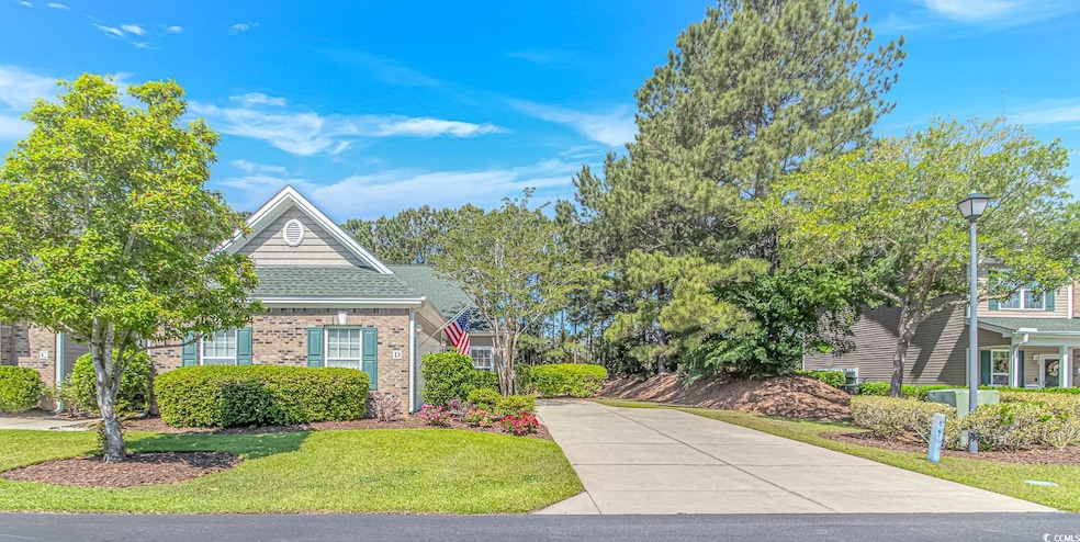 View of front of property with brick siding, drive