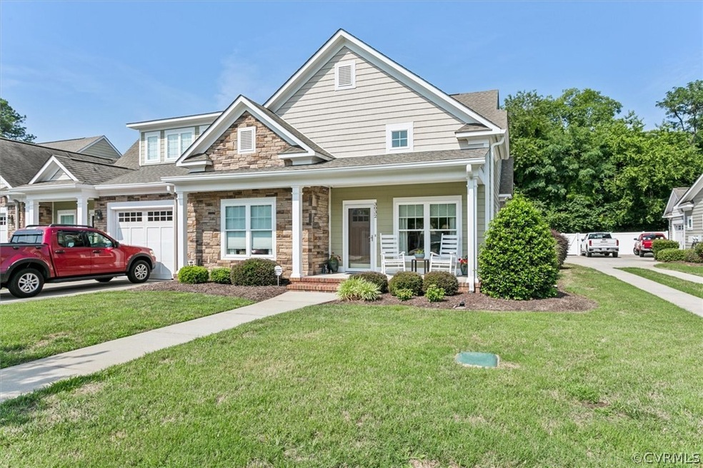 View of front of home featuring a porch, a garage,