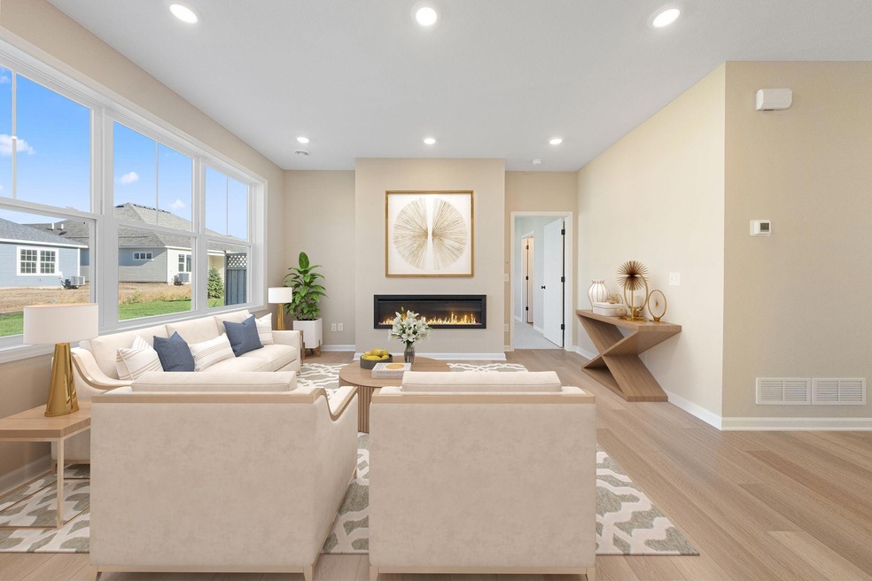 Family Room features a cozy electric fireplace and oversized windows to let the light stream in!  virtually staged