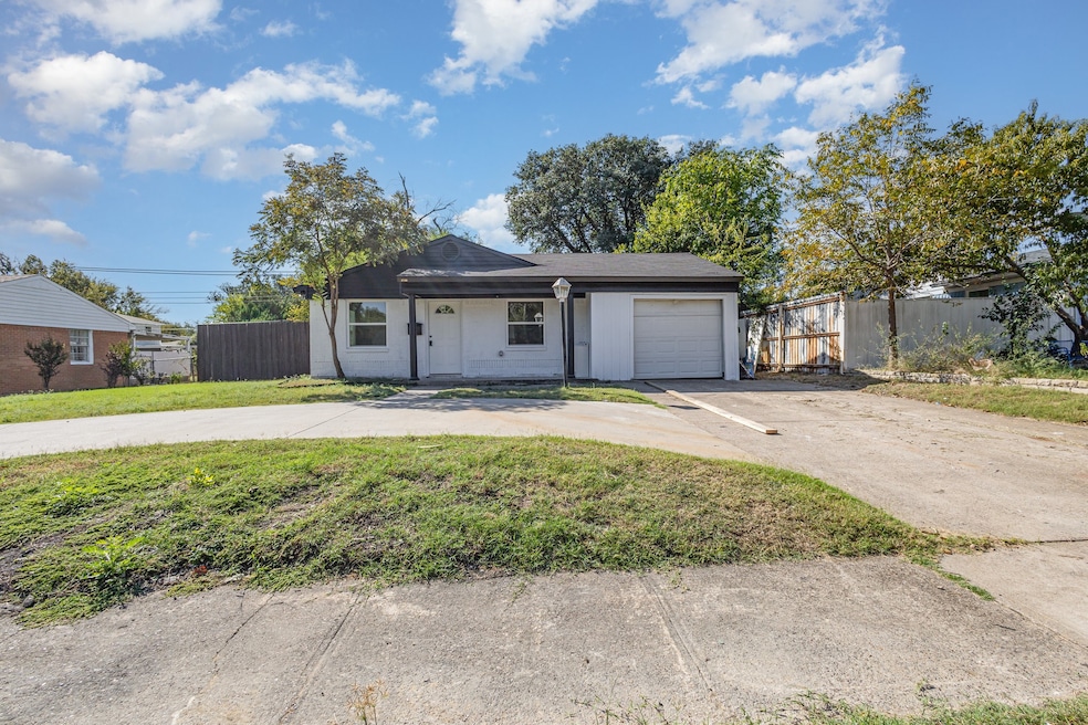 View of front of home featuring concrete driveway and an attached garage